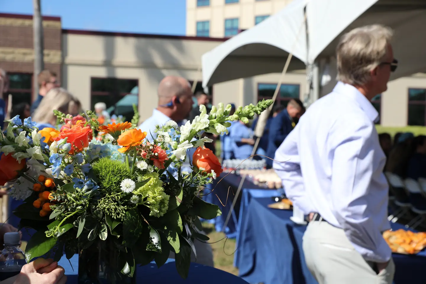 Bouquet of flowers and group of people at the HCA Florida West Marion Hospital celebration event.