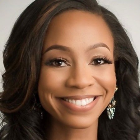 Professional headshot of LaShan Dixon, a newly appointed Board of Trustees member at TriStar StoneCrest Medical Center. She is smiling, wearing elegant earrings, with long wavy hair, against a light-colored background.