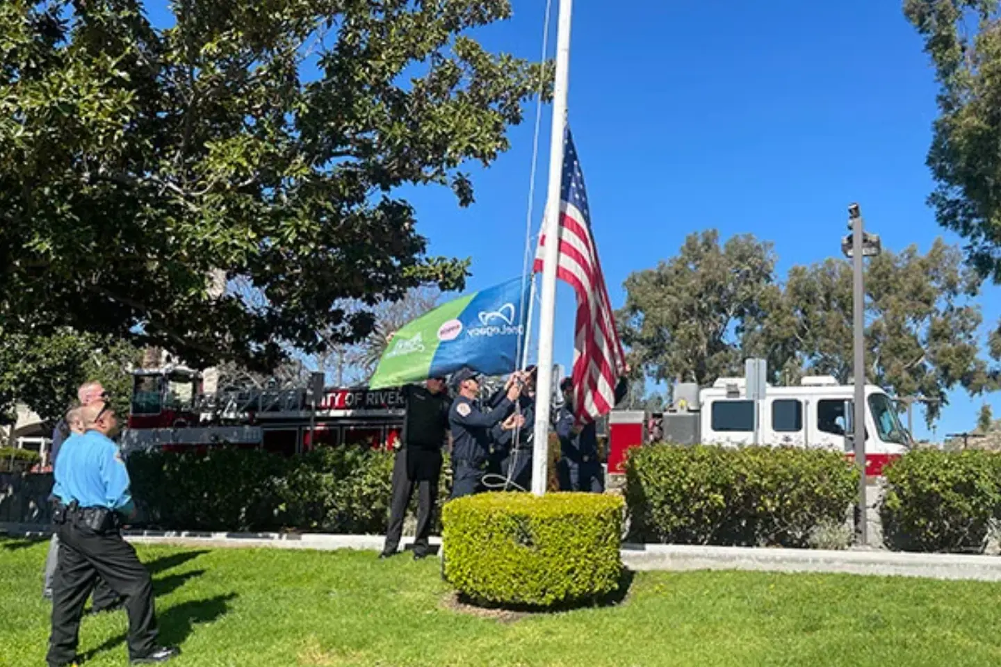 A group of EMT's raise the American flag and the Donate Life flag during the annual Donate Life Flag Raising ceremony.