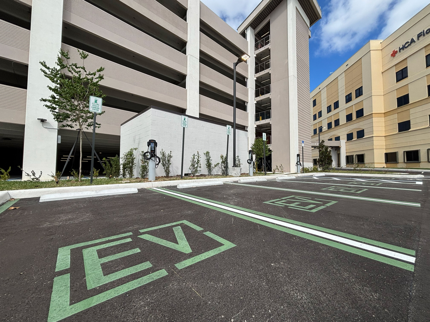 Exterior of St. Lucie's new parking garage with EV vehicle parking spots.