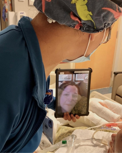 Yvette talks to a family member via video chat while in the CVICU