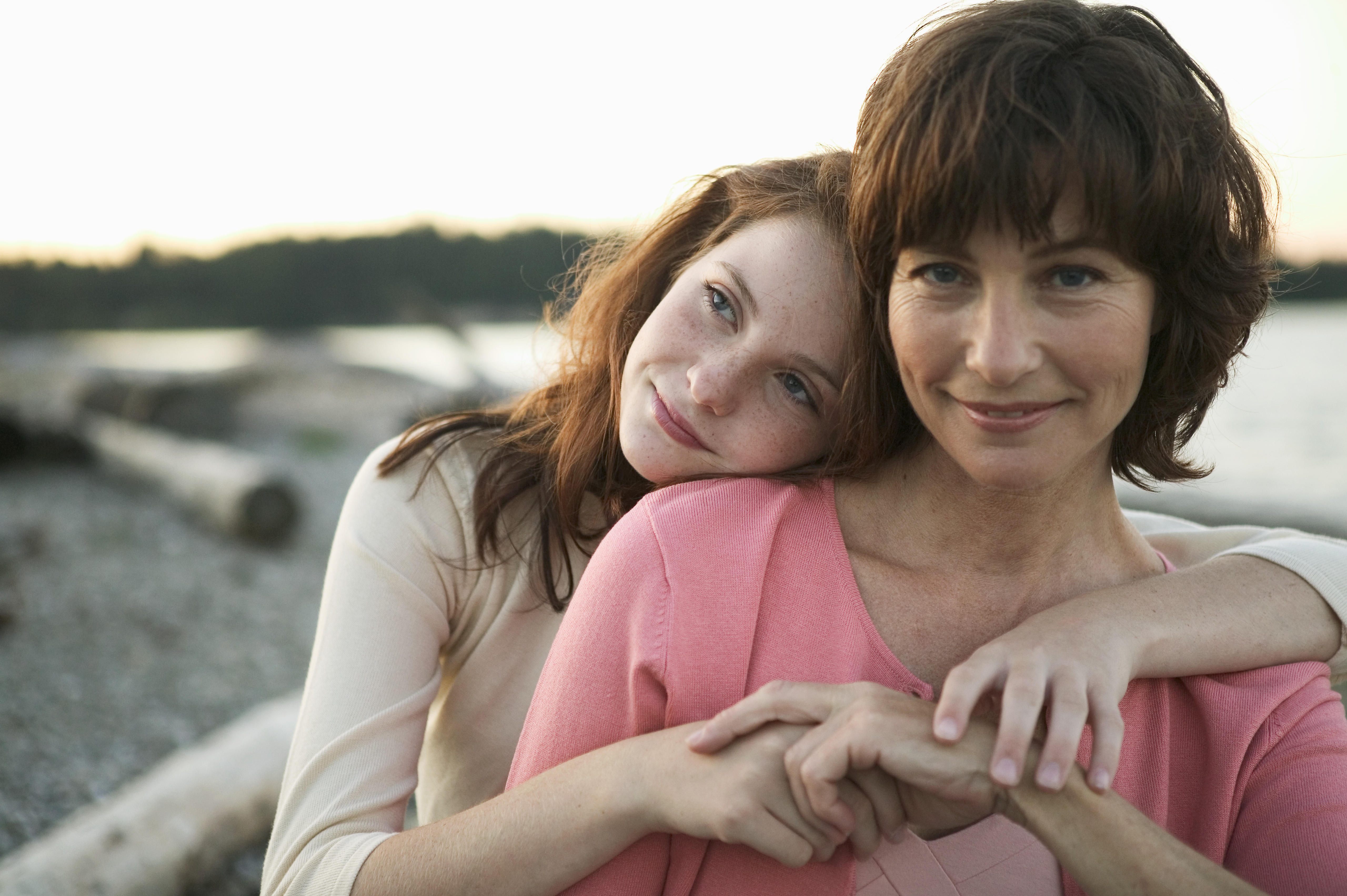 Two women share an embrace.