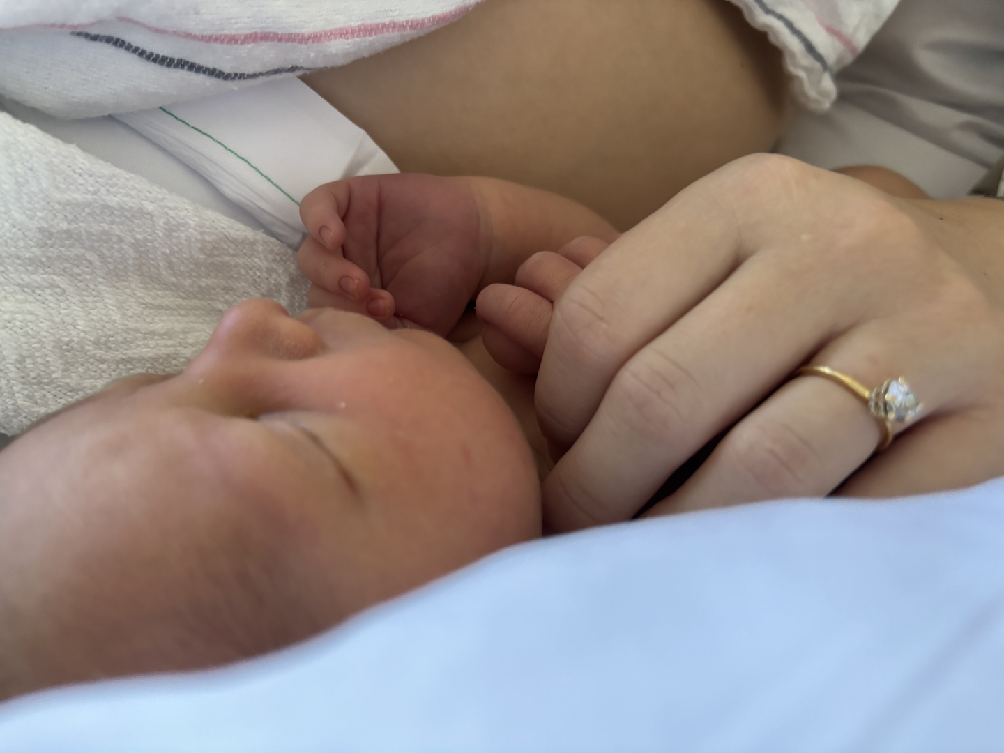 close up of person holding newborn baby