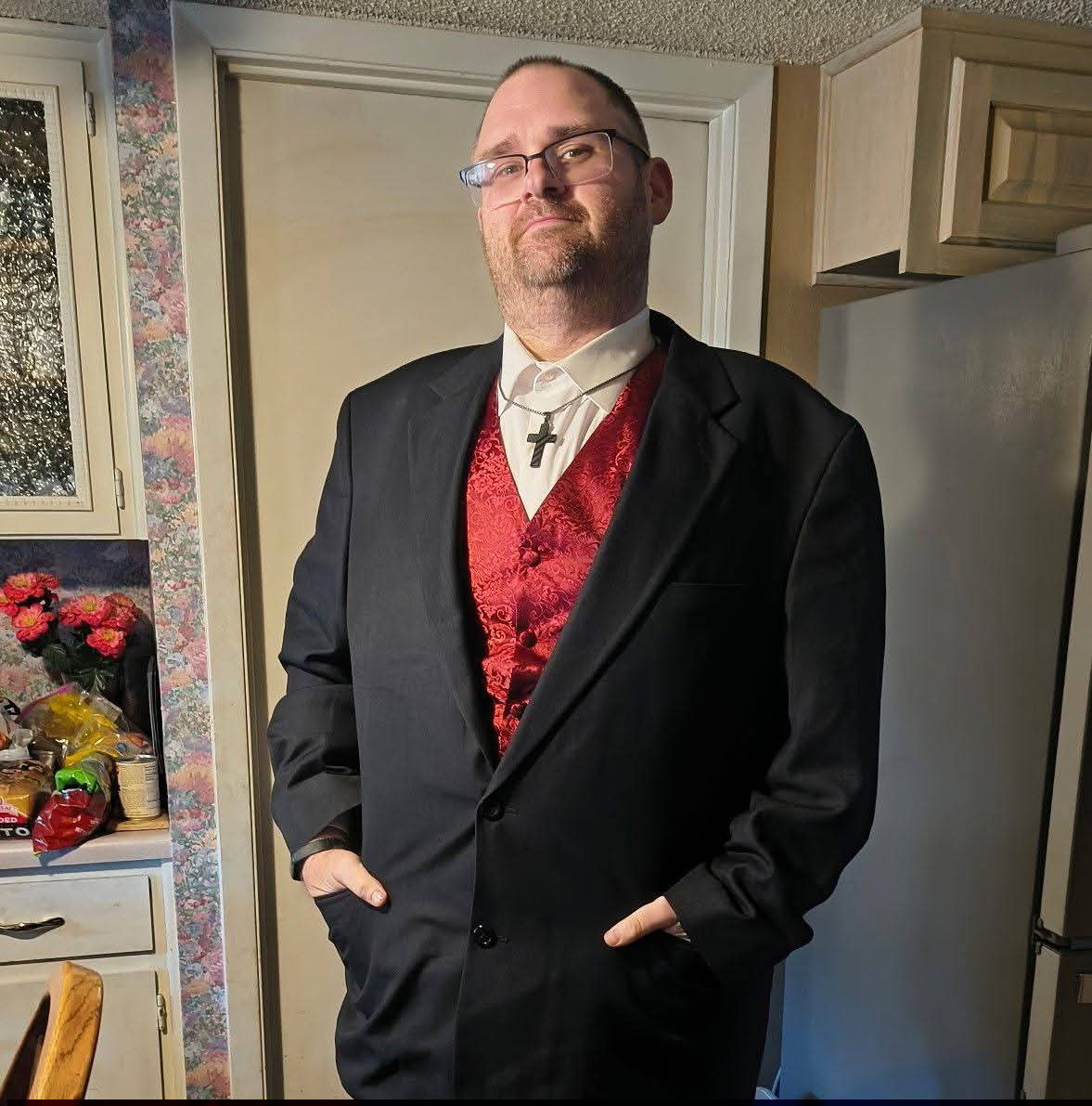  Nathan Ripple stands in a suit inside his house.