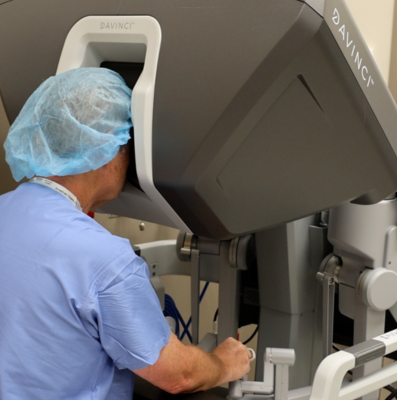 A surgeon performing surgery with a robotic surgical system.