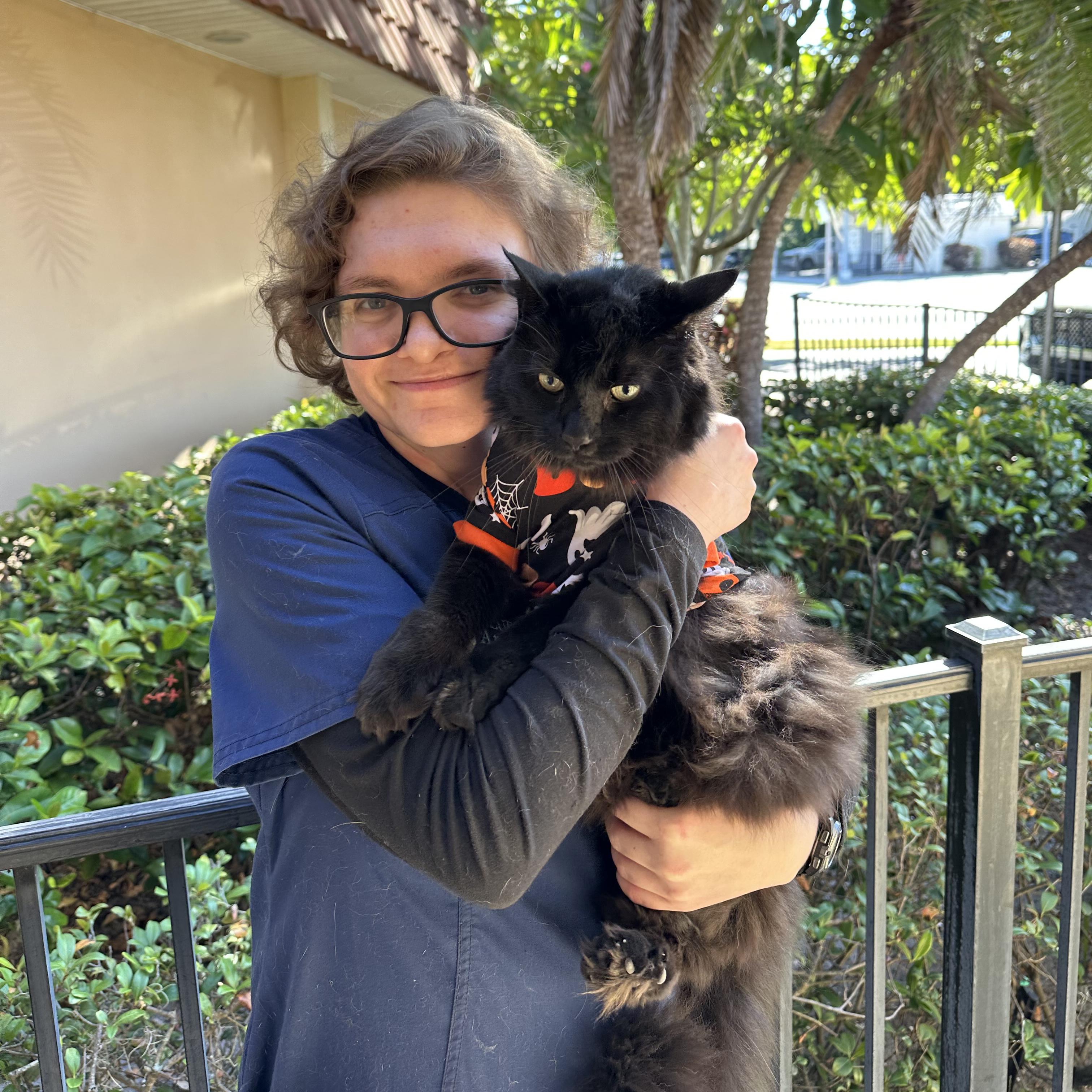Madeline Boggess, Vet Tech, with her pet black cat Darkshire