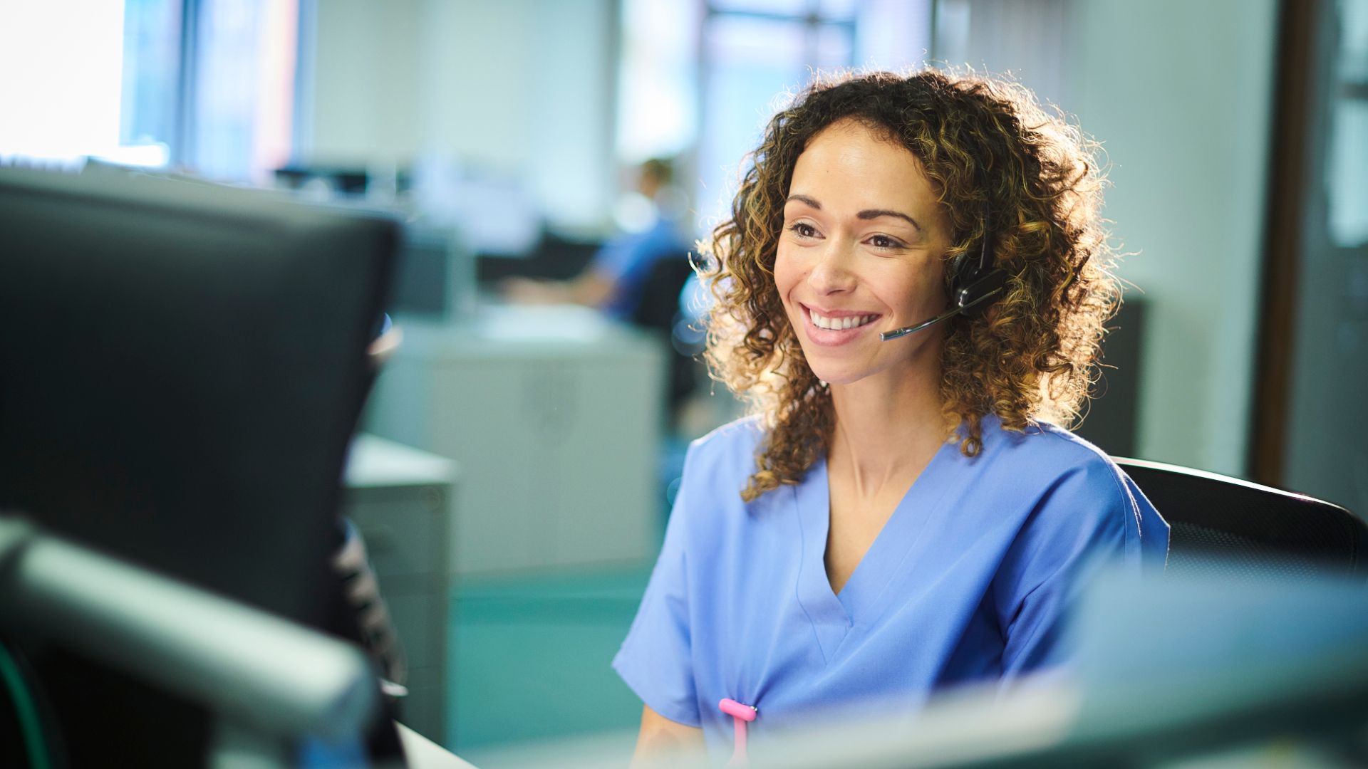 A virtual care assistant at her cubical.