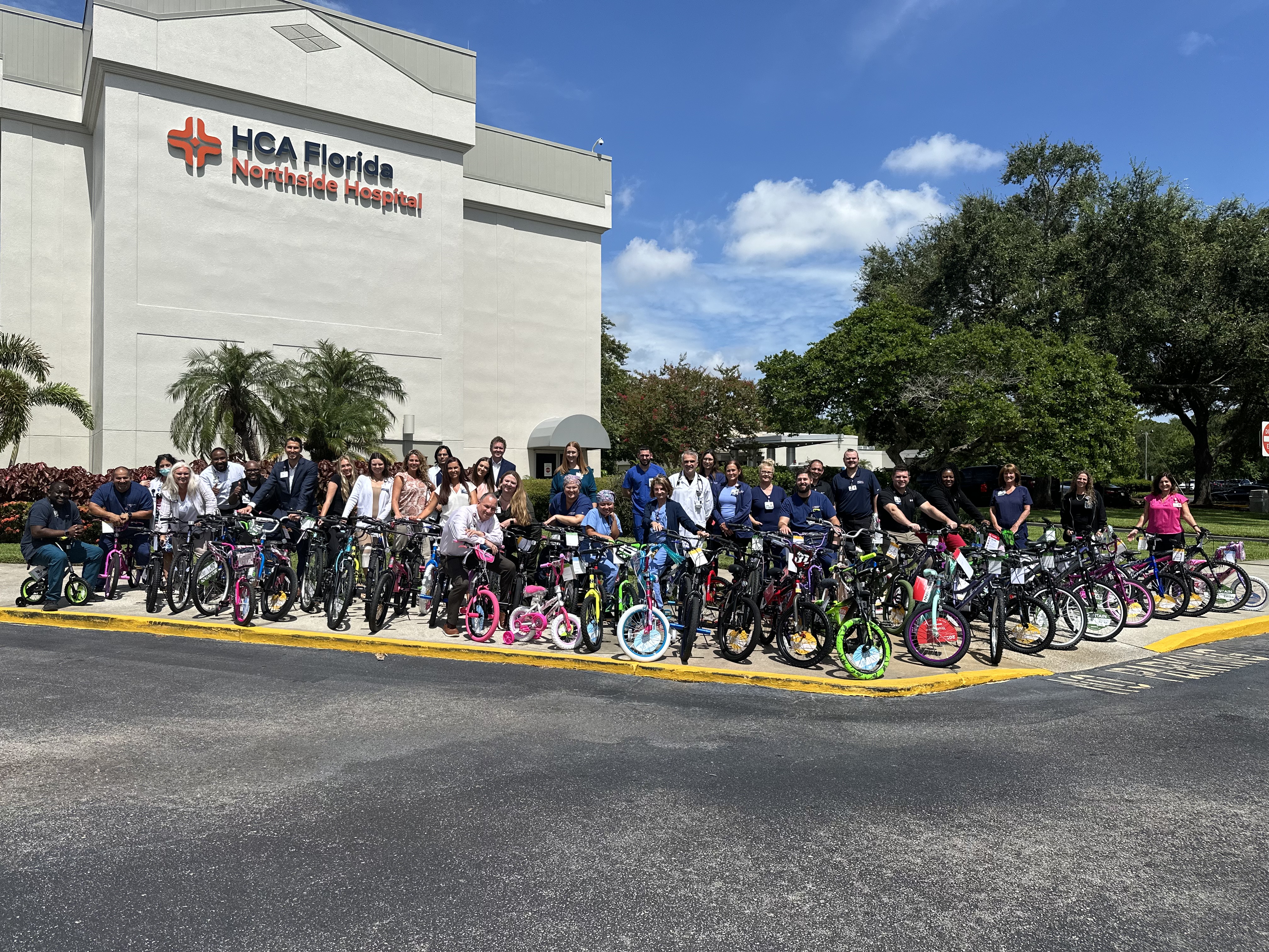 A group photo of volunteers with donated bicycles.