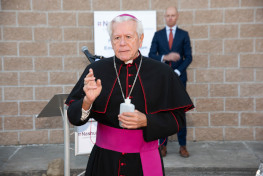 Bishop conducts a blessing with holy water.