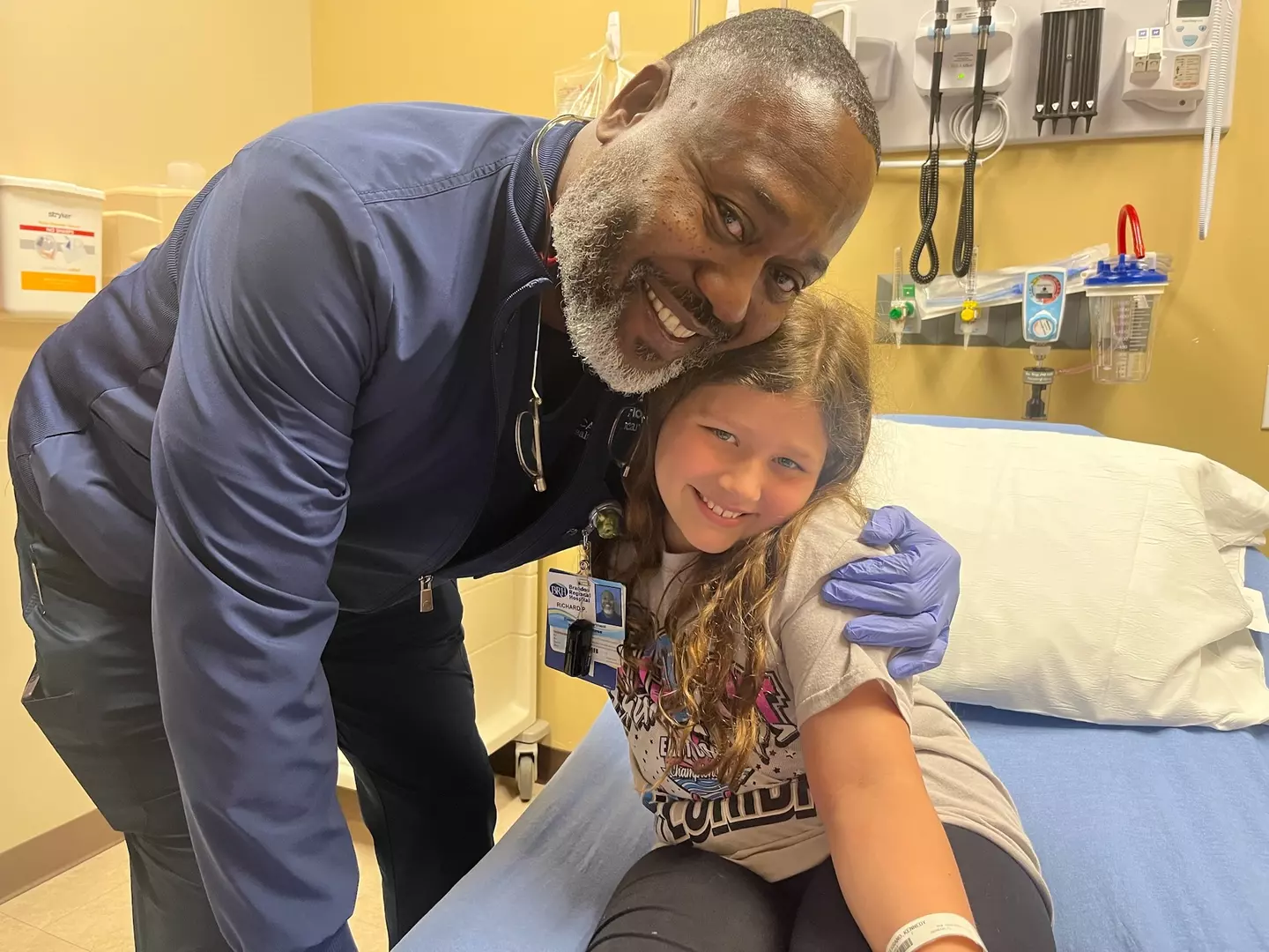 Photo of Richard Pass embracing a patient.