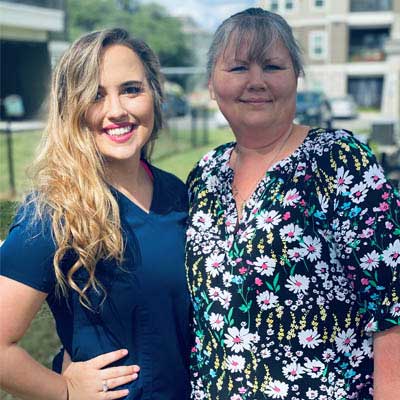 Hailey Guido standing outside with a nurse.
