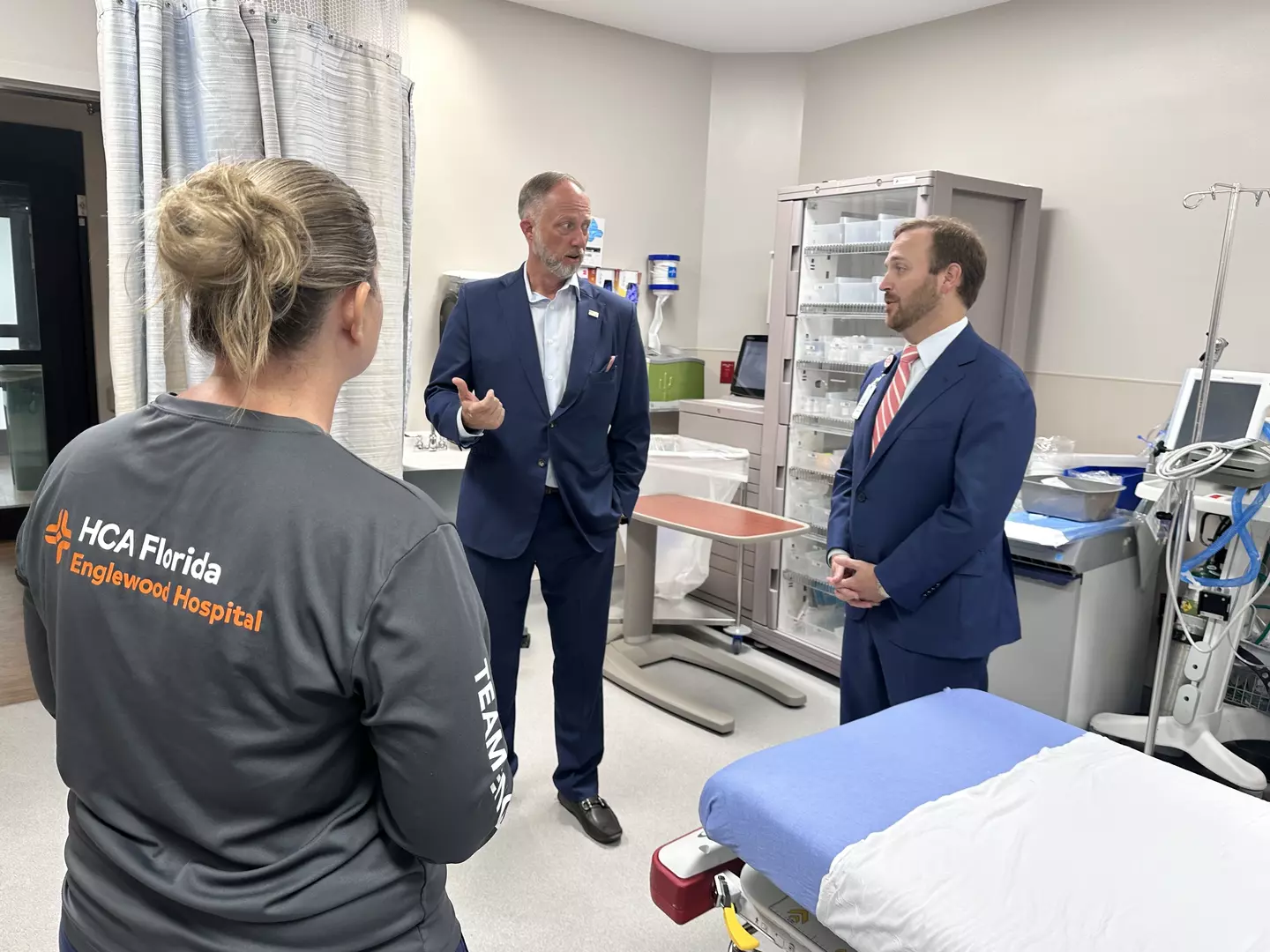 Danny Nix and Joe Rudisill visit with Emergency Room Director Maggie Fisher in hospital room