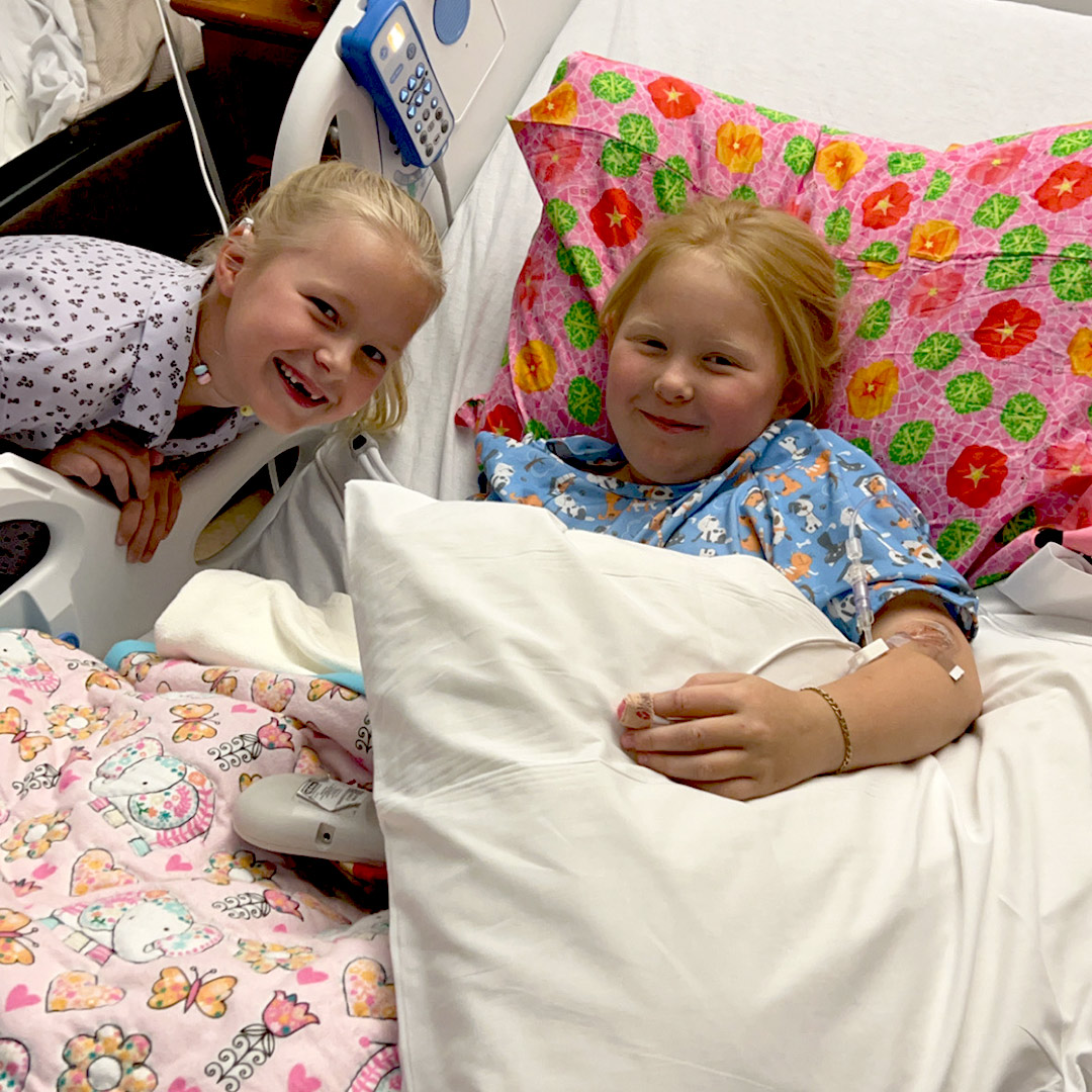 Gracie visits with her sister in her hospital room.