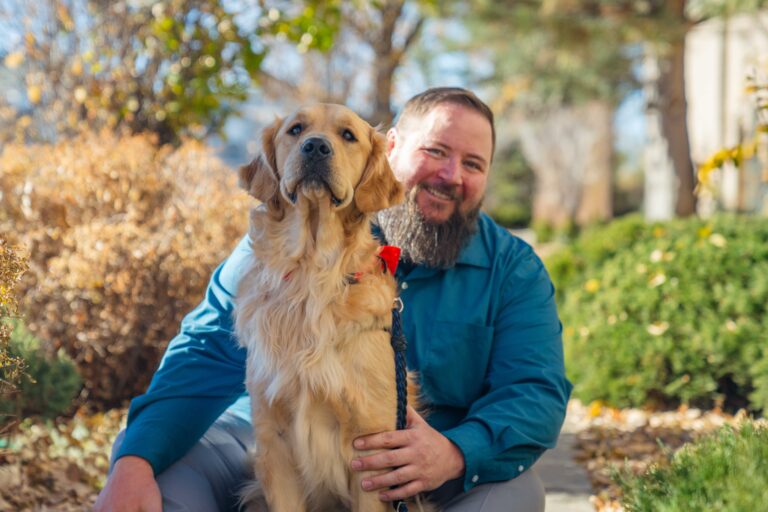EMS Director Doug and Thumper (golden retriever) service dog.