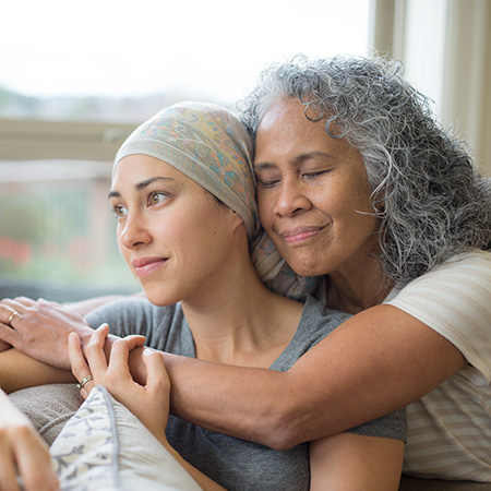 Mother and adult daughter embrace