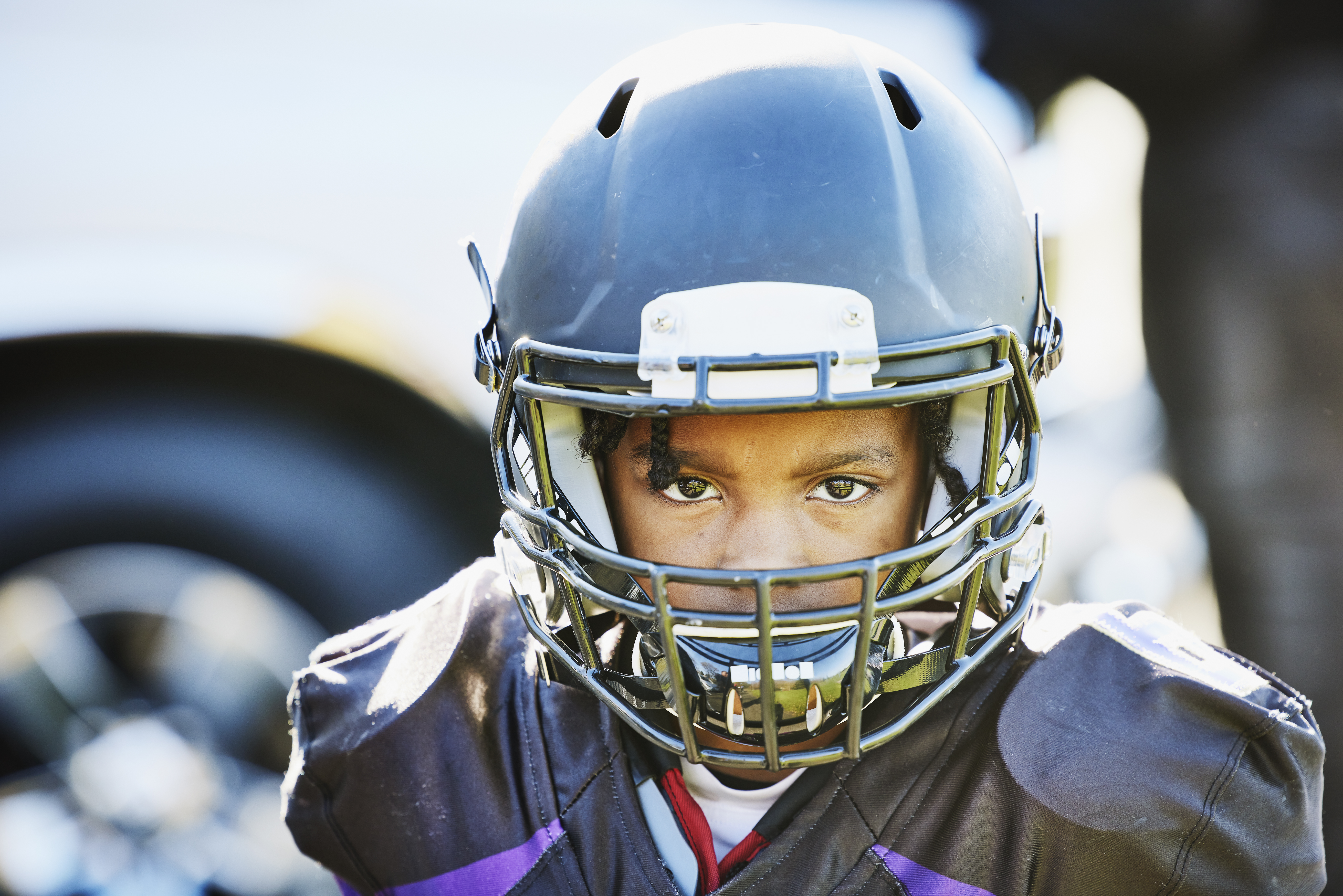 Young man with a football helmet on focusing on the game.