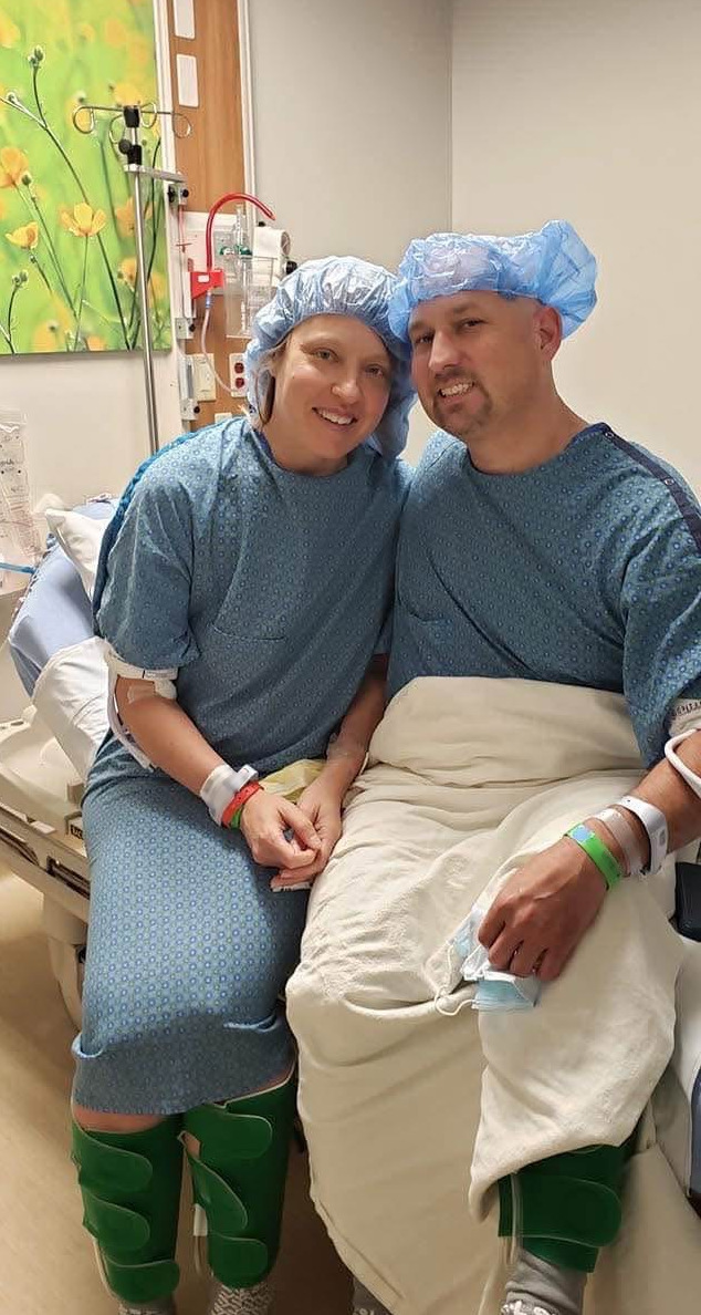 Stephanie and Ryan Daniels pictured together sitting on a hospital bed.