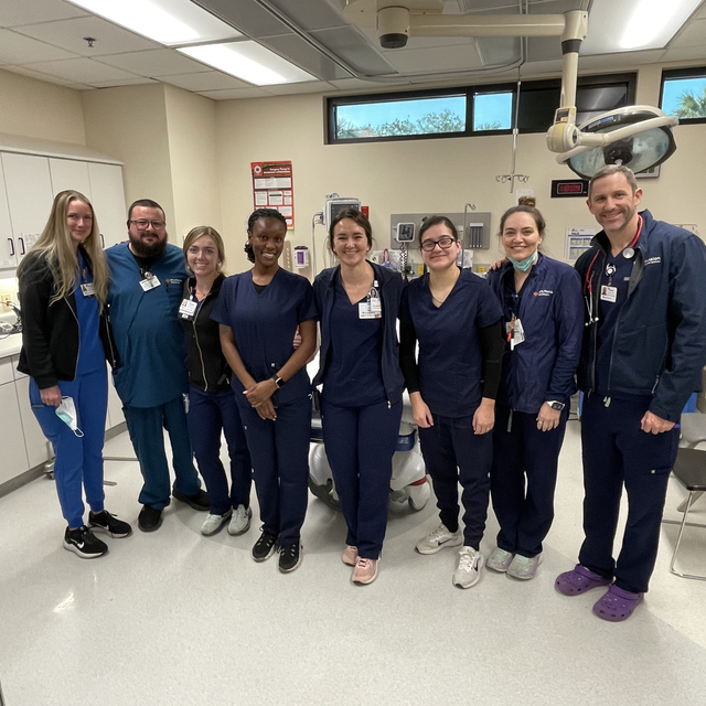 Group of healthcare providers standing in operating room.