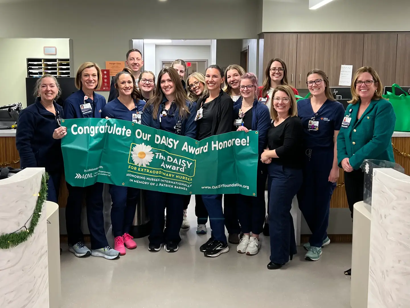 Shannon Irwin and Lauren Demarco with the emergency care team hold a banner.