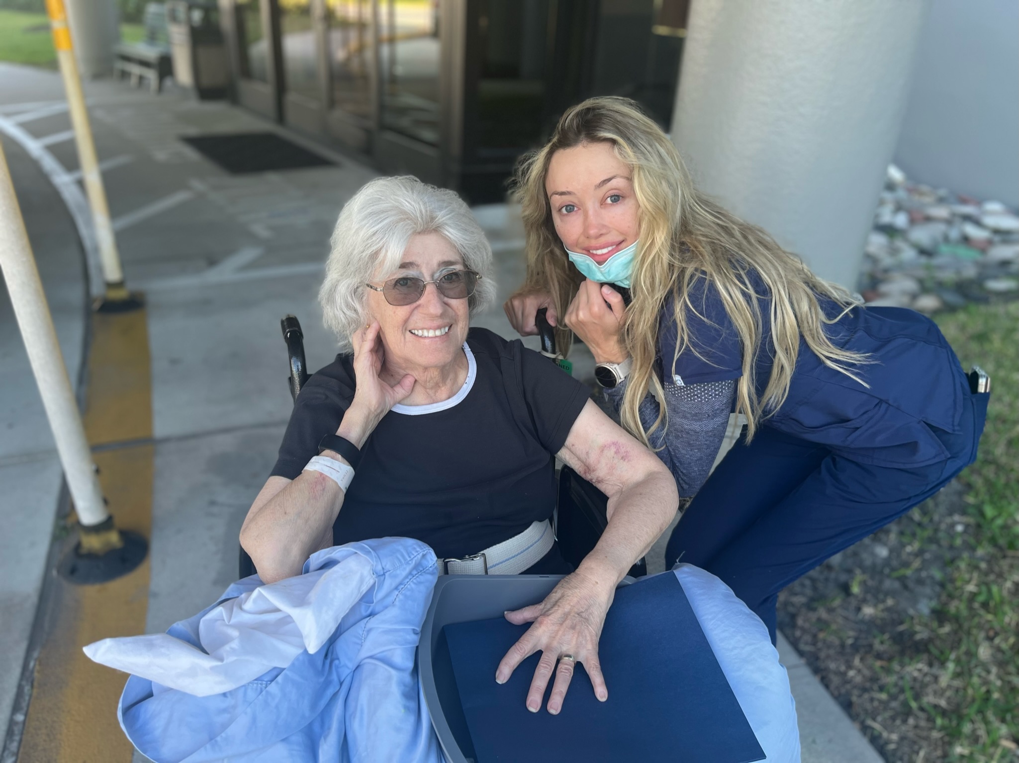 Rachel Trockman posing in wheelchair with nurse