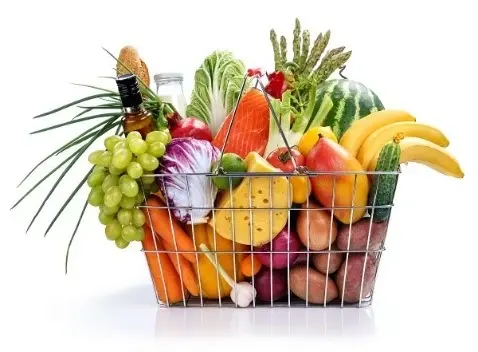 A shopping basket filled with various fruits and vegetables.
