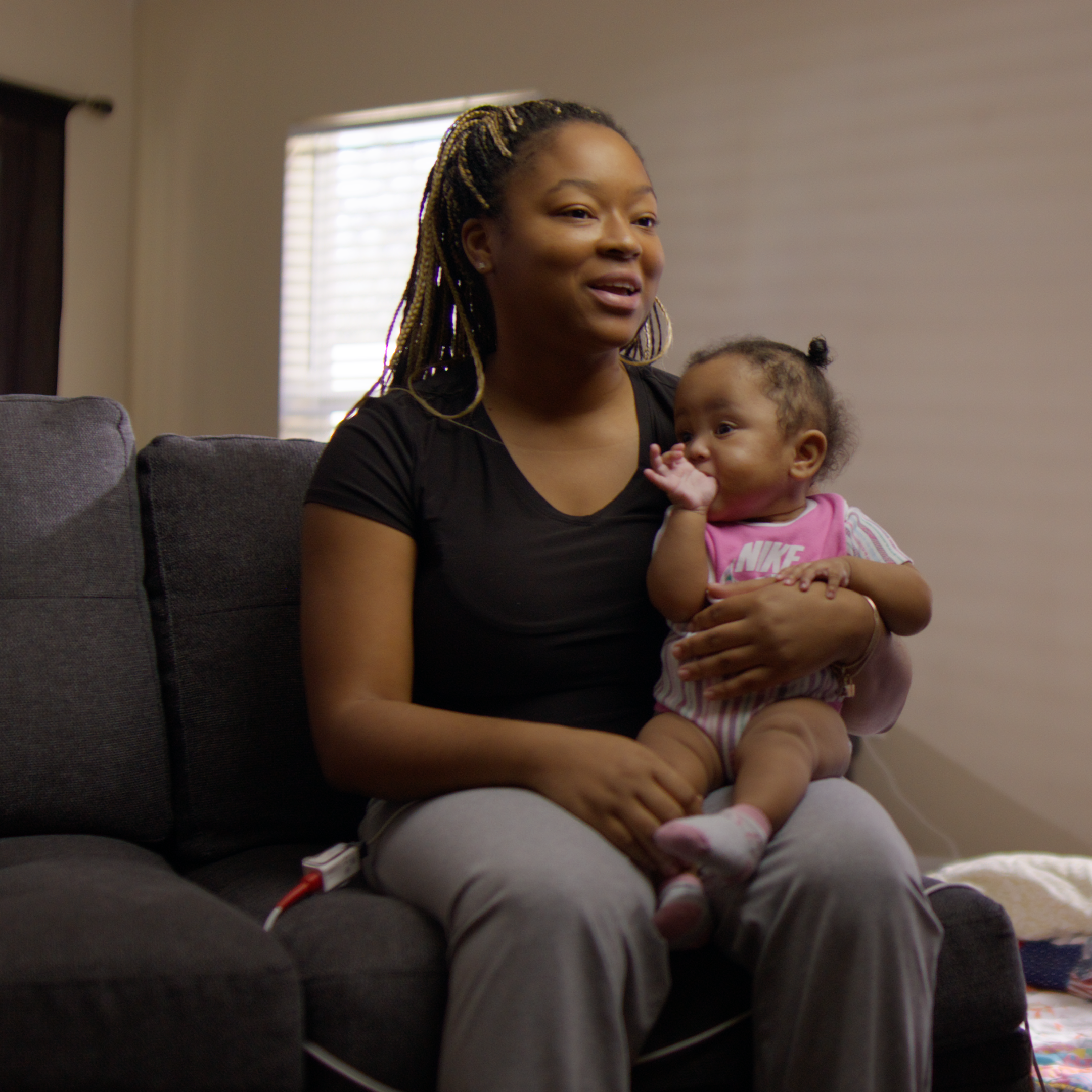 Taylor holding baby Tamiyah Saunders