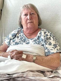 Patsy sitting up in a hospital bed.