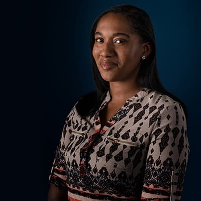 Vonnie M. wearing a patterned shirt and smiling.