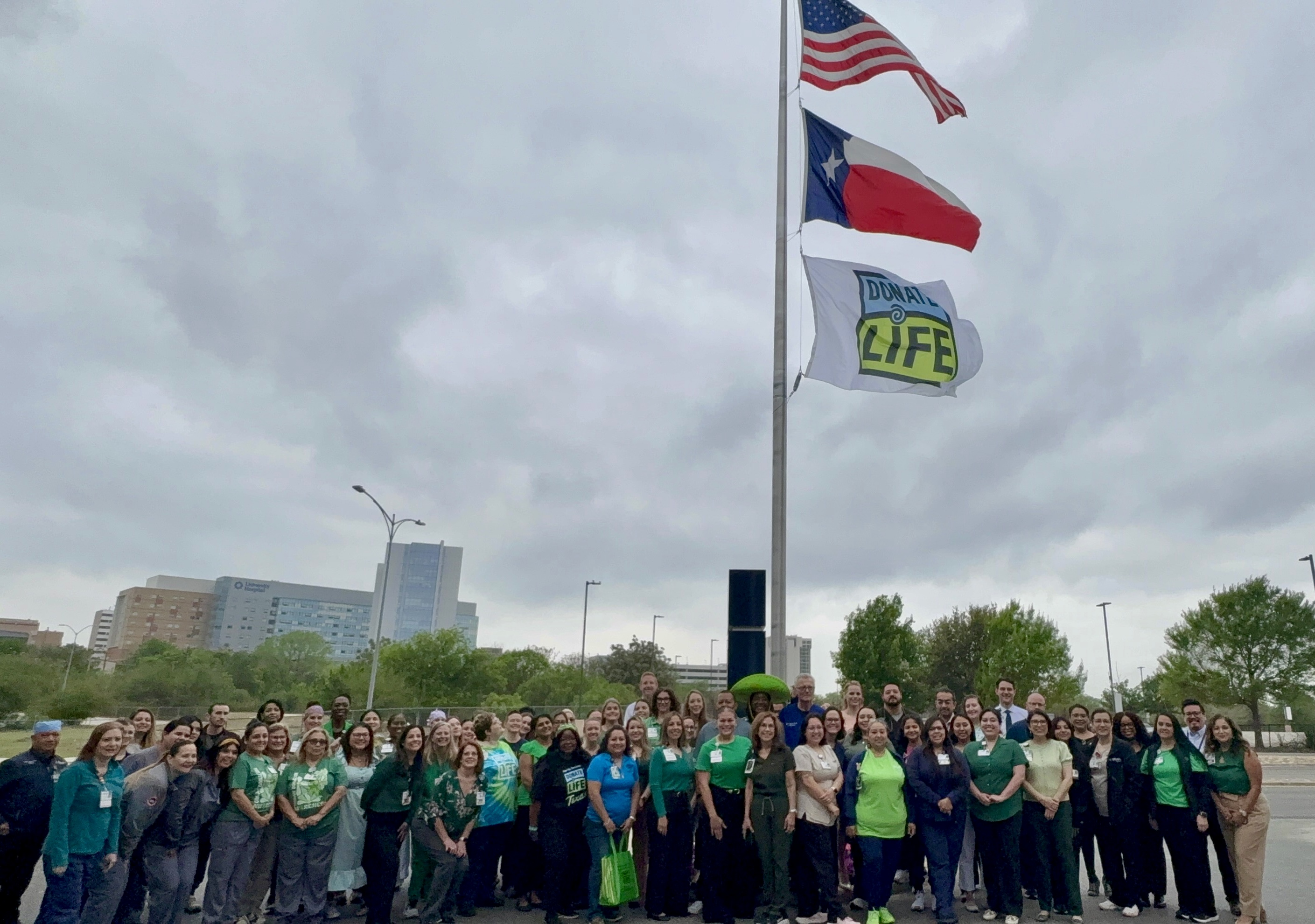 Methodist Hospital Specialty and Transplant colleagues raise the Donate Life flag to celebrate donate life month.
