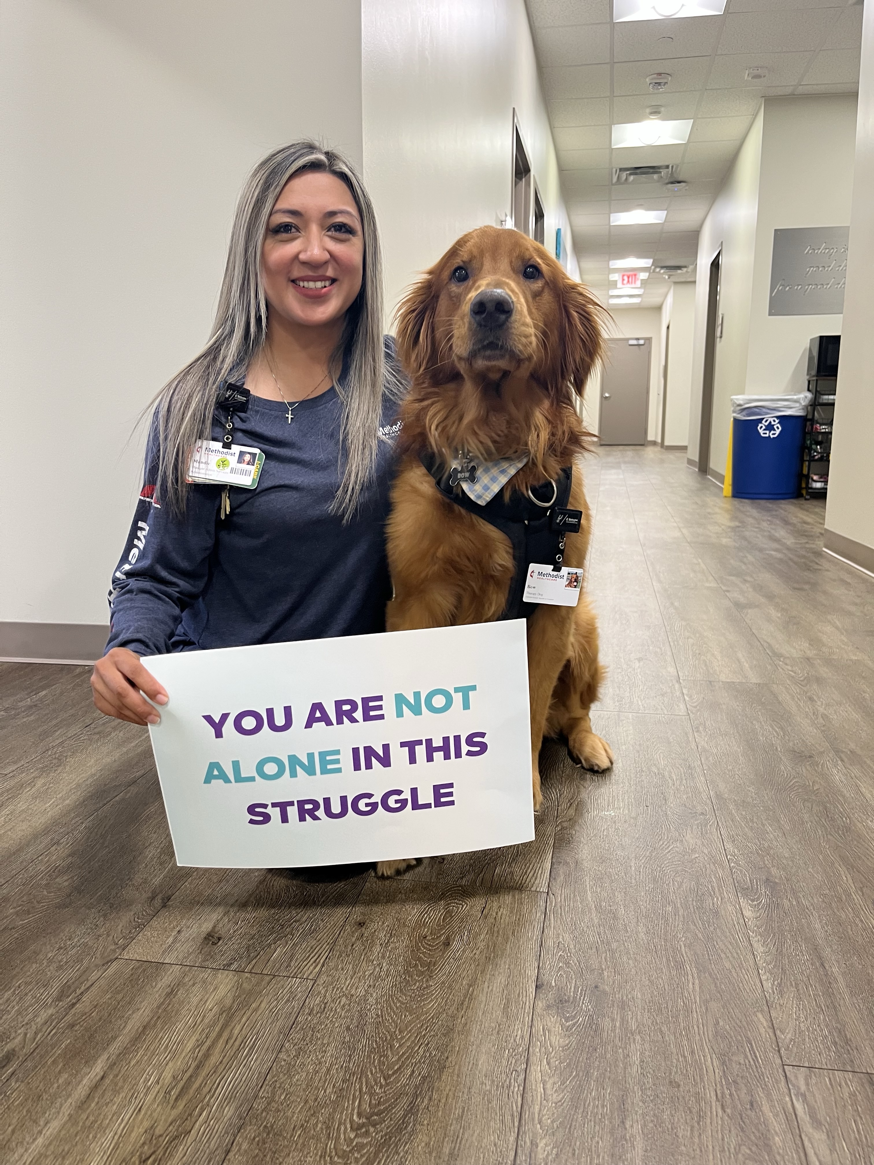 Methodist team member holds sign of encouragment on World Mental Health Day.