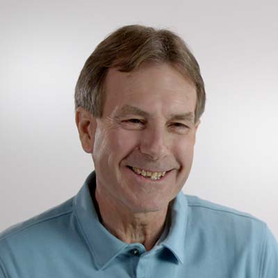 Rick Osborne smiles while wearing a blue collared shirt.
