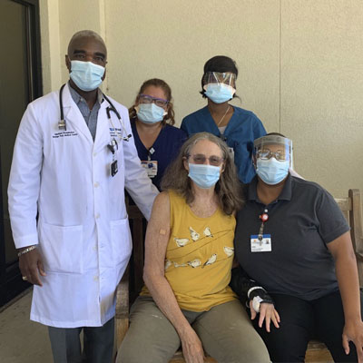 Barbara Huelsbeck with ICU nurses and doctors.