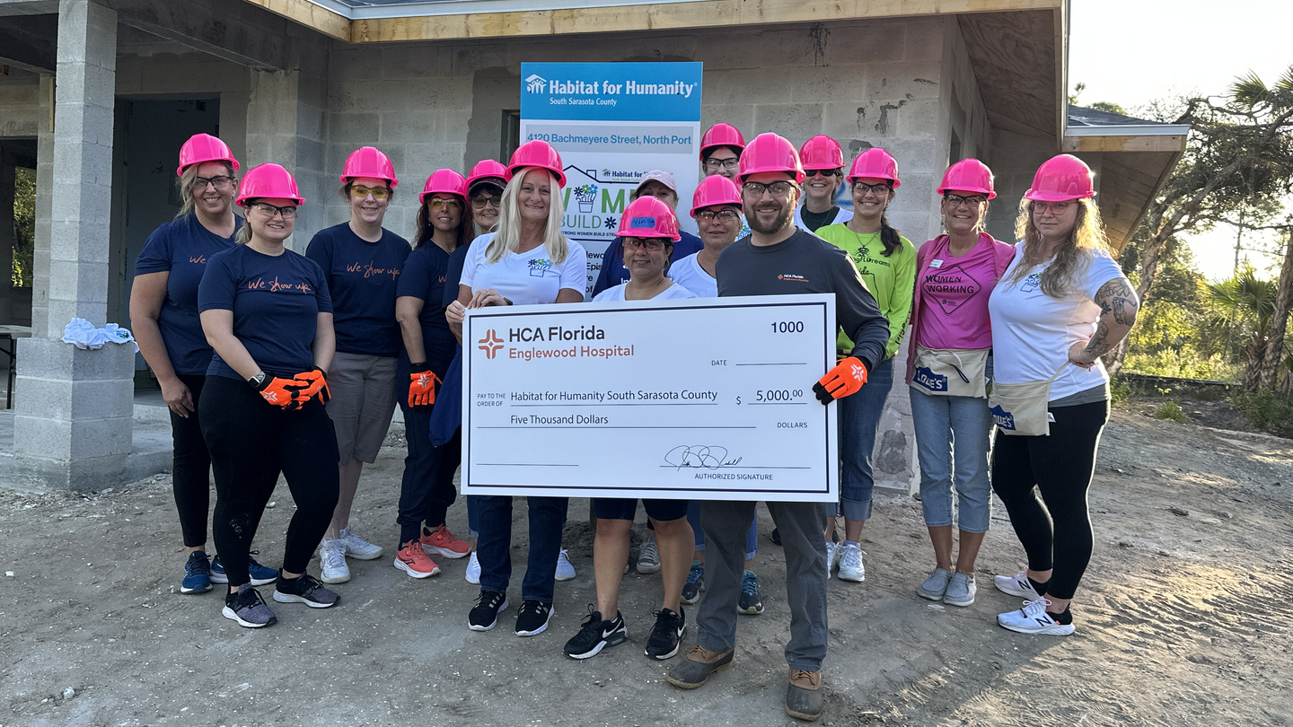 HCA Community Volunteers with check for Habitat for Humanity