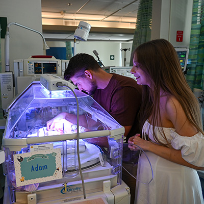 Father Vlad and mother Valentyna visiting their twin babies in the NICU.