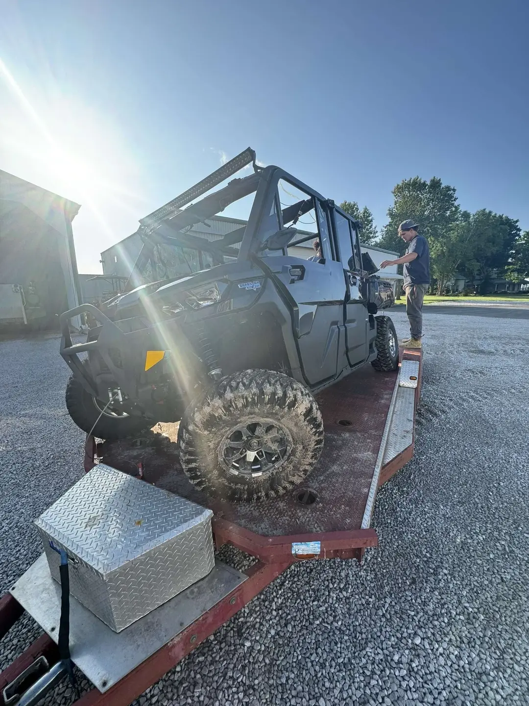 the crashed UTV that Bo Bryant was driving in his accident, on a platform to be hauled off