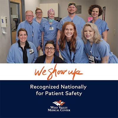 A group of hospital staff smile with text on the image that reads, "We Show Up. Recognized nationally for patient safety. West Valley Medical Center."