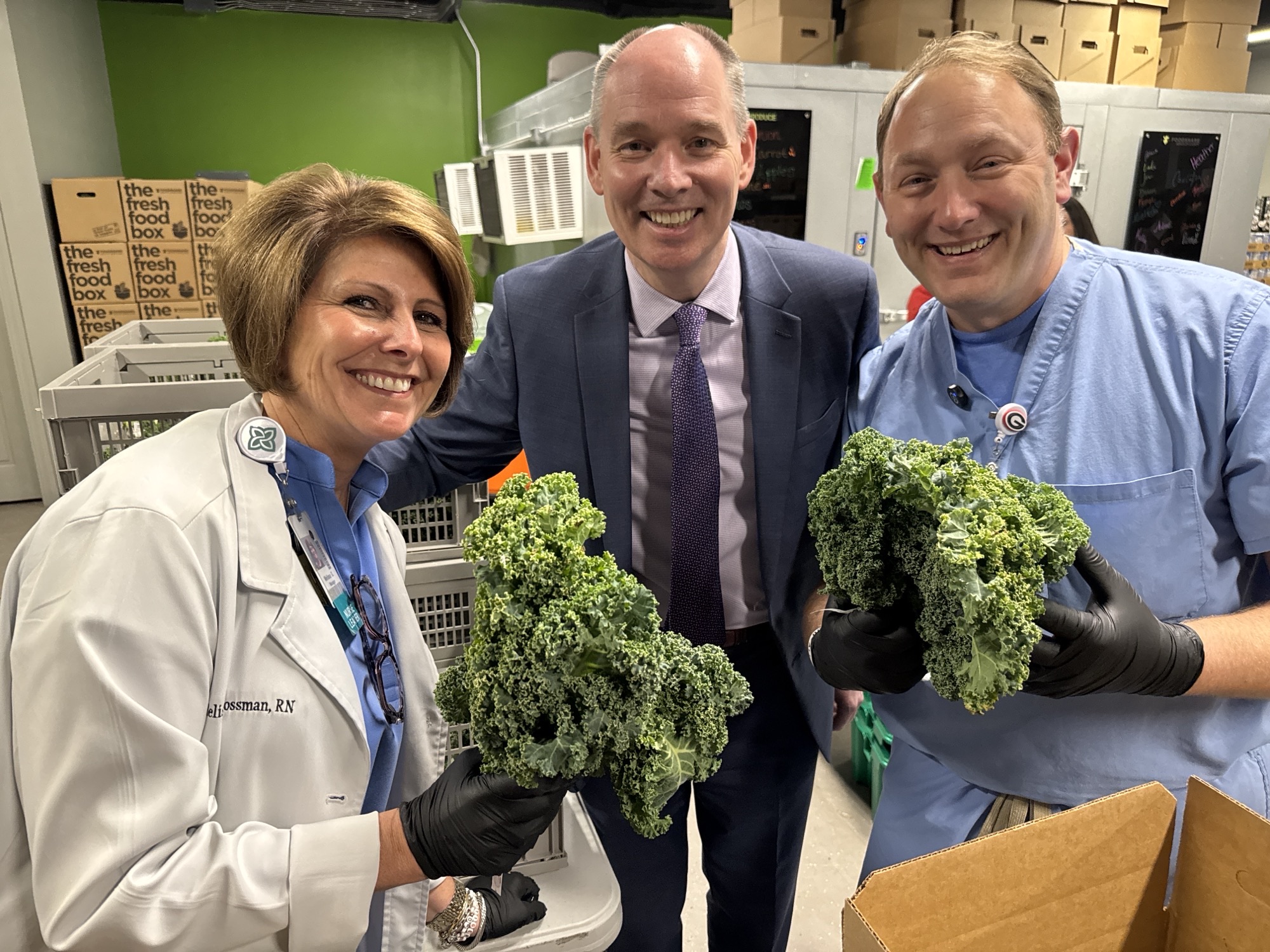 Photo of Melissa Grossman, RN, Jeff Wilson, President, Trident Health and CEO, Trident Medical Center; and Brian Evans, VP, Surgical Services, Trident Medical Center holding vegetables.