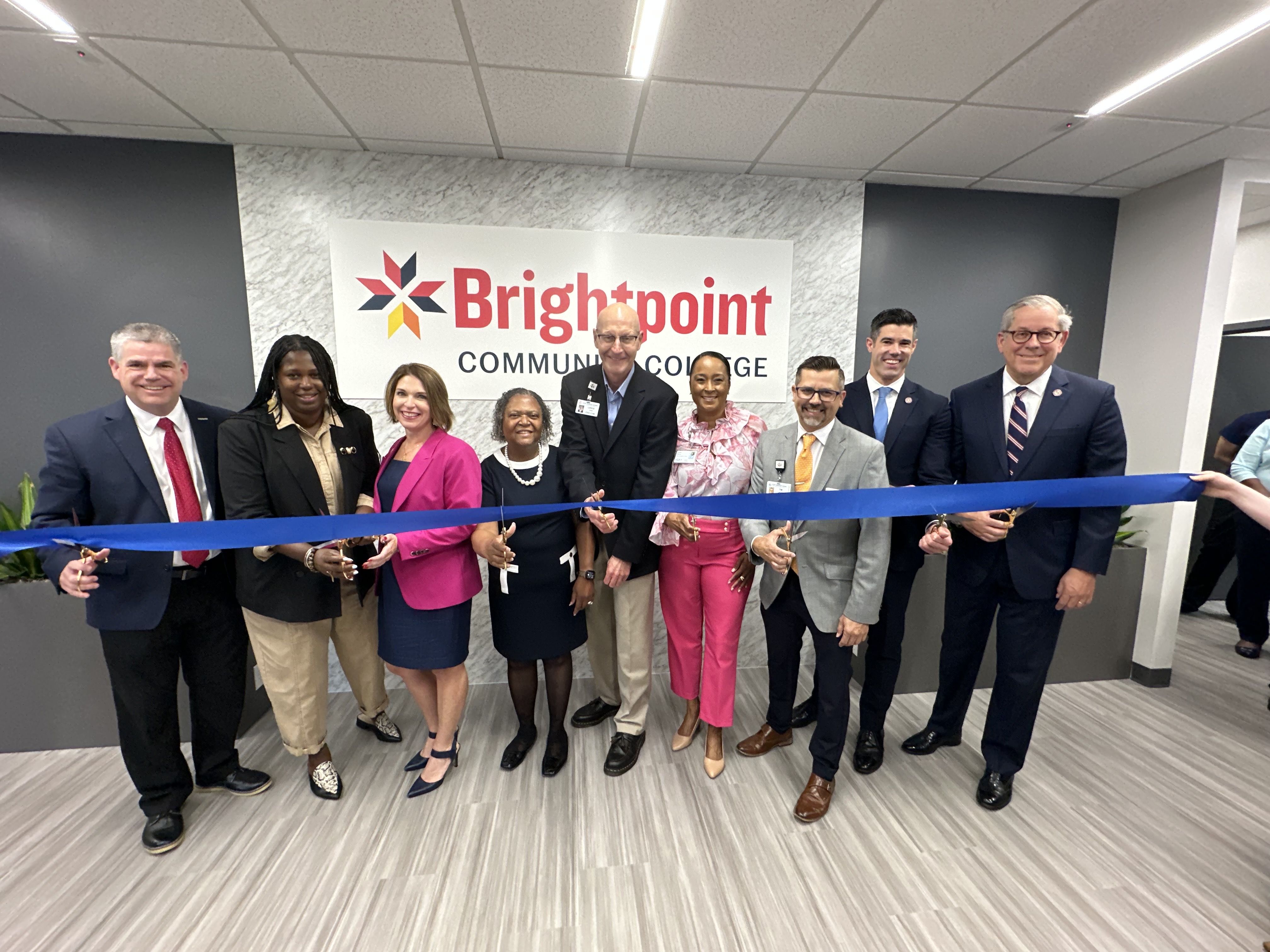 A group of HCA and local officials are cutting a ribbon.