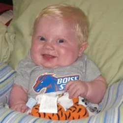 Baby Landon wearing a Boise State onesie.