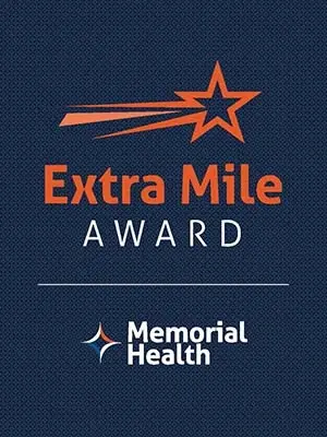 The Memorial Health Extra Mile Award logo.