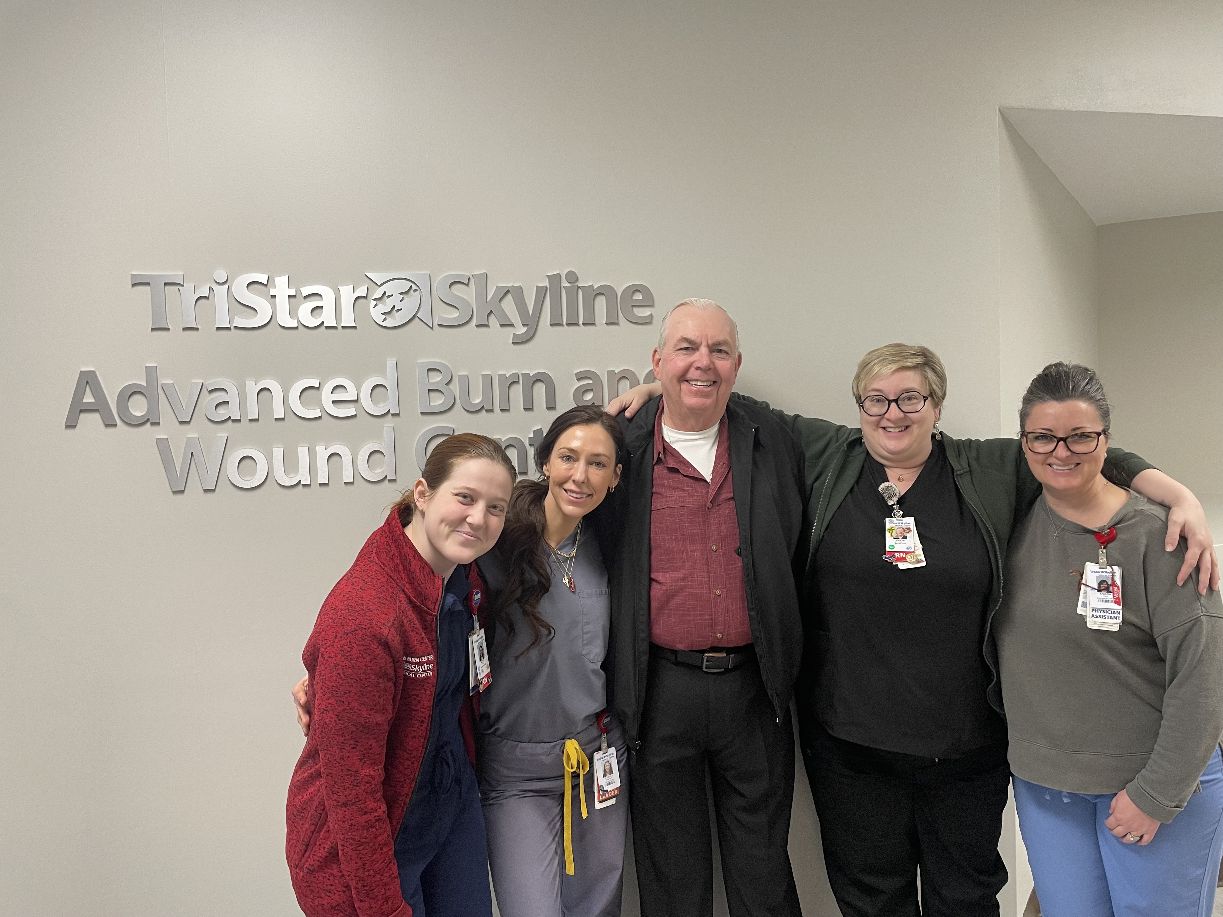 David Johnson and the care team standing in front of the TriStar Skyline Medical Center Advanced Wound & Burn Care signage.