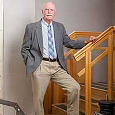 Duncan Sessoms smiles while standing next to a set of stairs used during physical rehab.