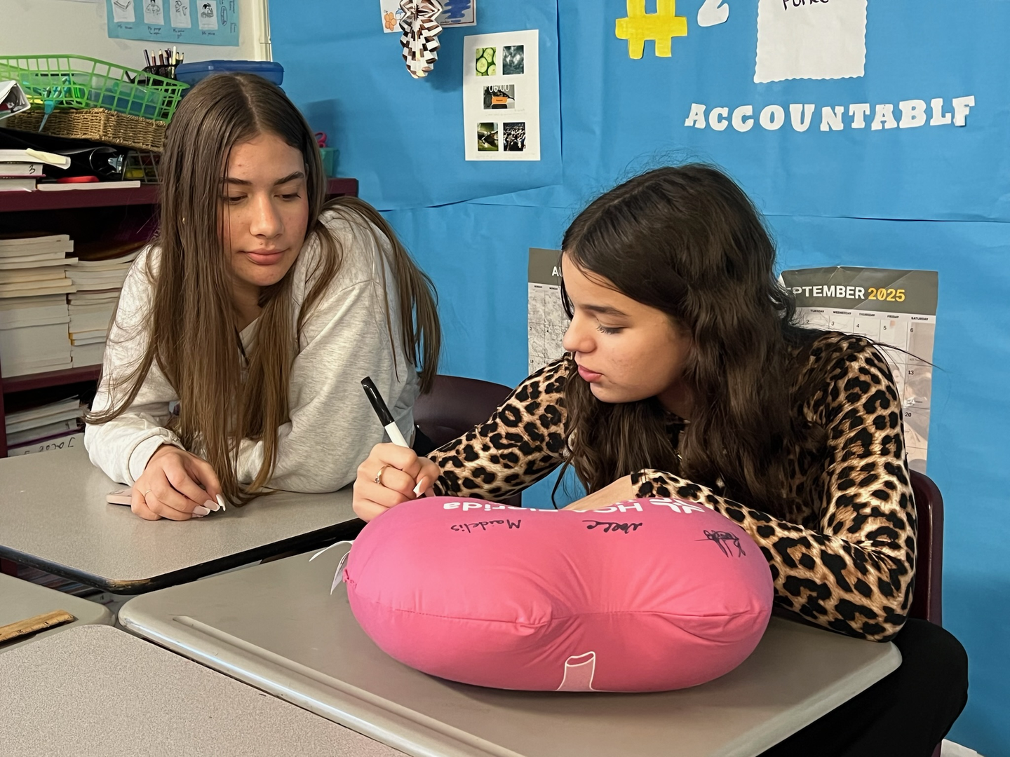 Students signing a lung pillow