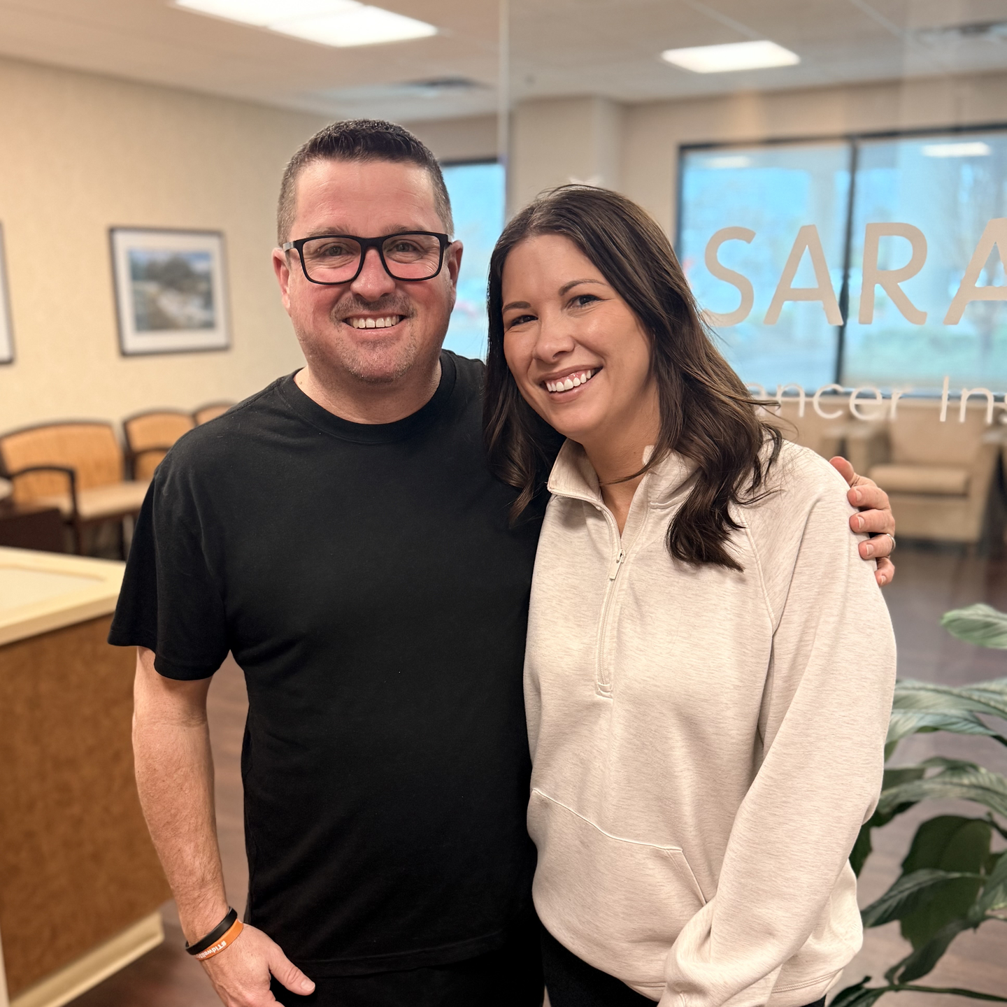 Jamey with arm around wife