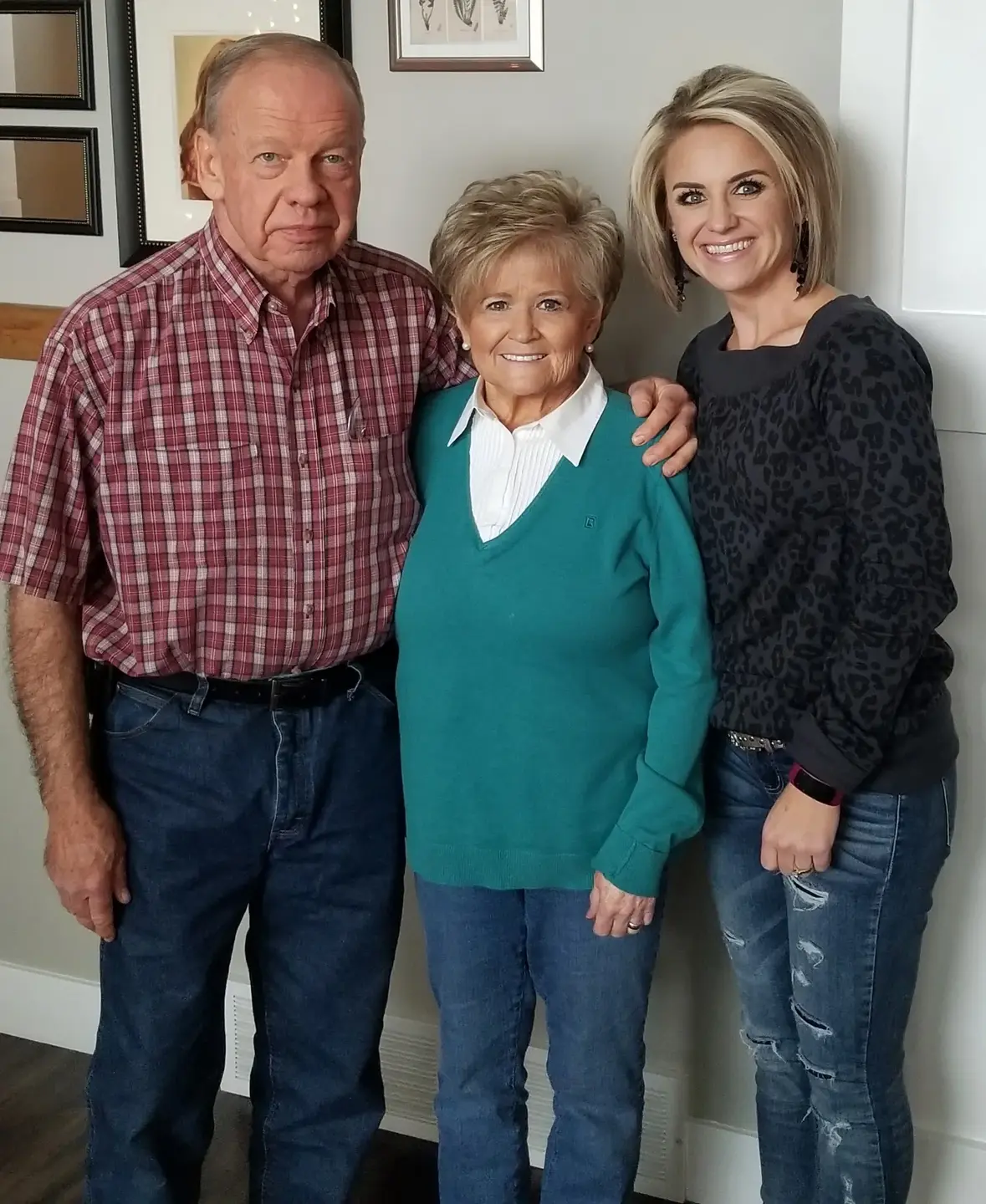 Gina Corry with her parents in their home.
