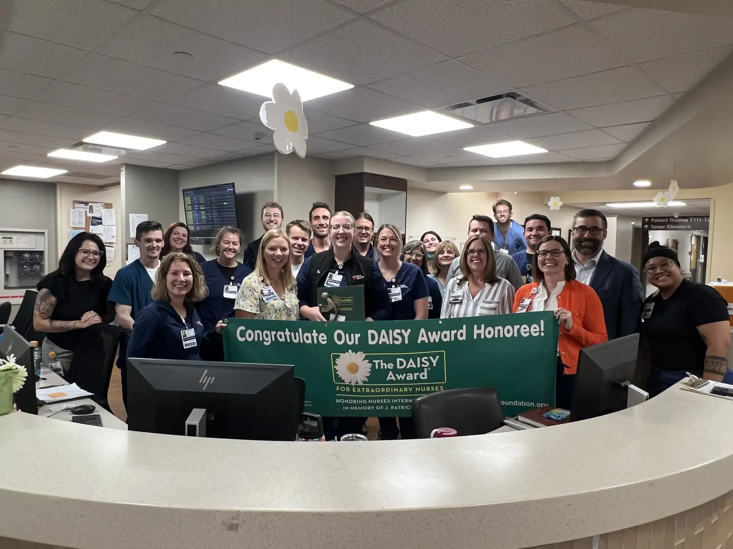 Nikki Erdman and staff celebrate her DAISY Award winner.
