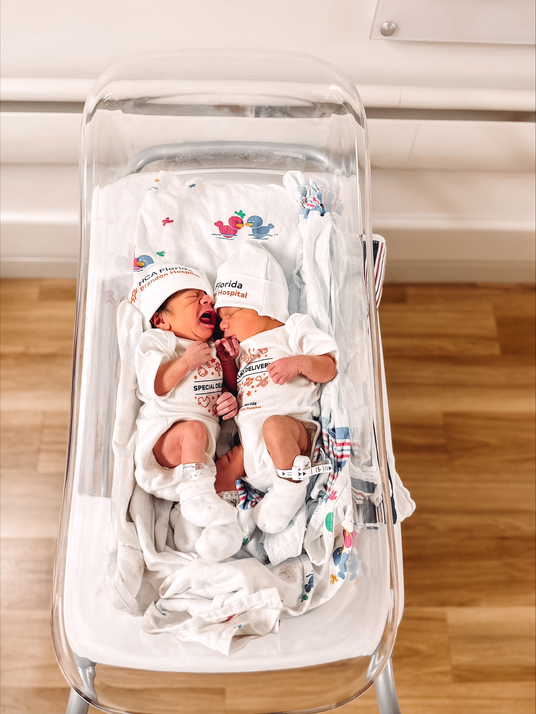 Identical twins boys, Jaylen and Jru Pung are together in their crib.