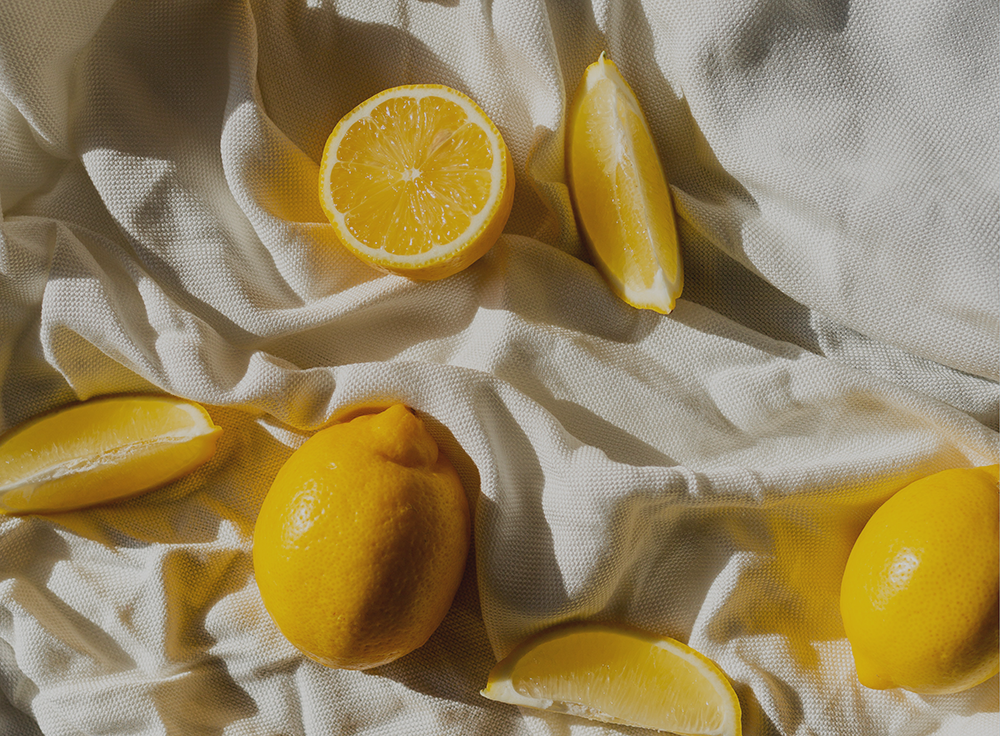 Lemons on top of a white cloth.