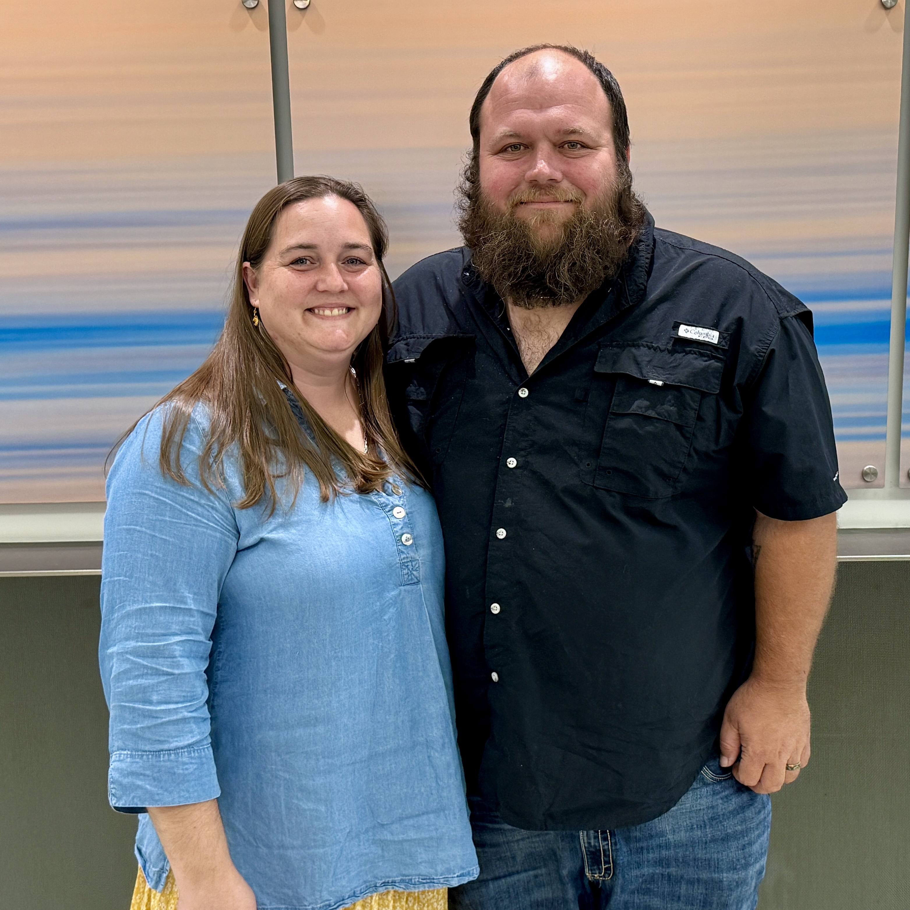 George Bishop and his wife Samantha Pankow posing and smiling for a picture.
