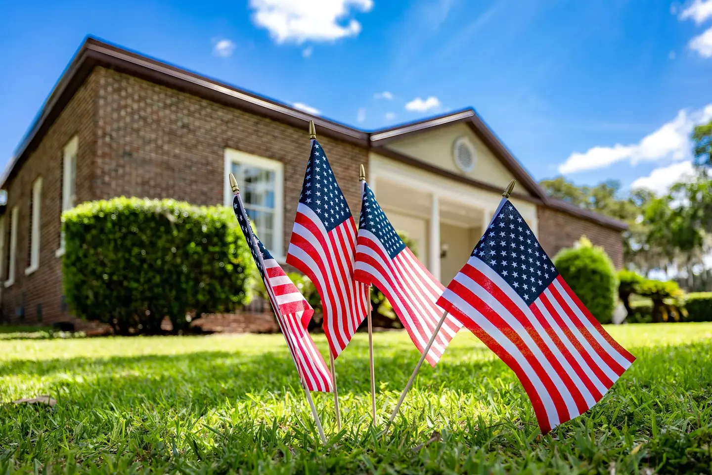 Small American flags in the lawn.